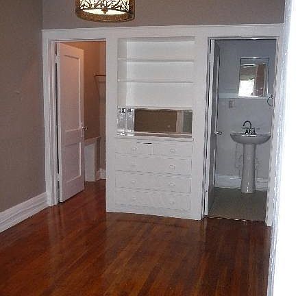 dining/office area w built in dresser with closet and bath to either side.