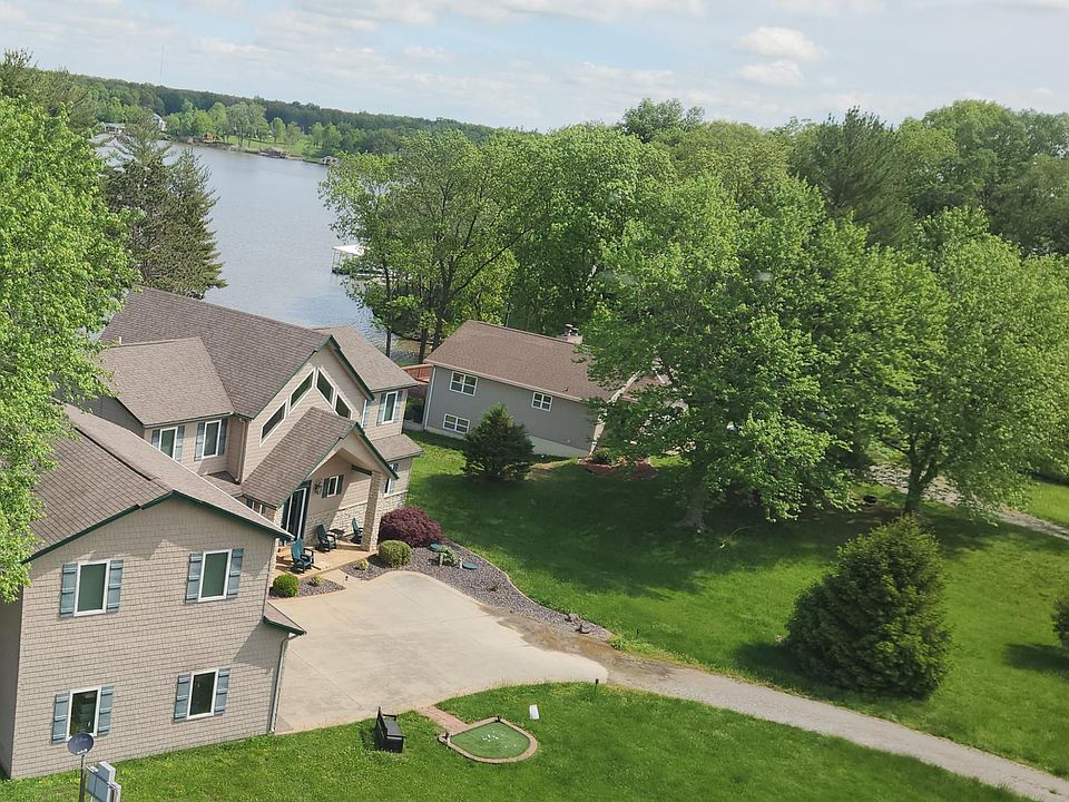Apartment aerial view (top left). Spacious front yard including golf driving range.