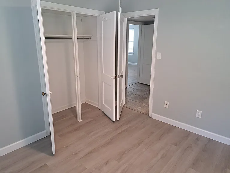 guest bedroom #1 with double closet doors