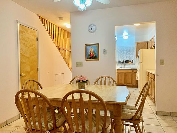 Dining area that leads from living room to kitchen; half bath on the left