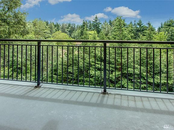 Spacious balcony which backs to a greenbelt with a private storage unit access, on far side of building away from the freeway.