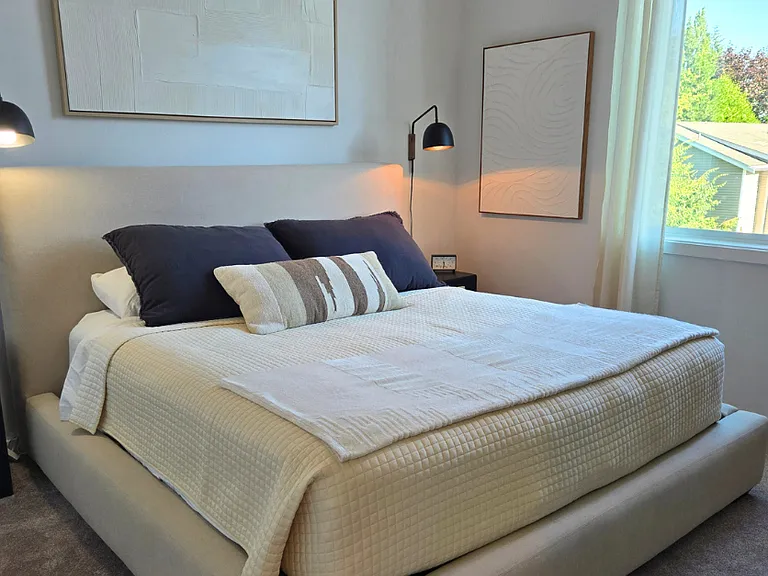 Your primary bedroom has 18 ft. ceilings, huge South facing windows for all day light and custom paint and lighting