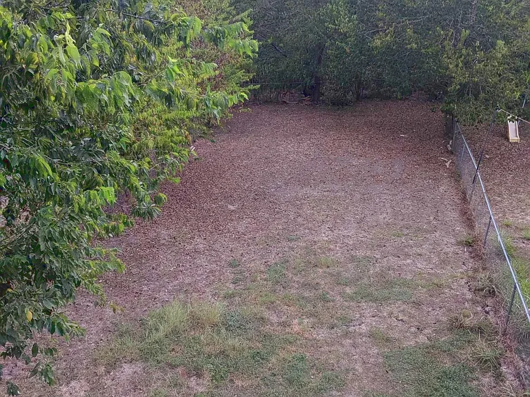 Very large backyard is fully fenced and not shared. Peaceful woods and dry creekbed beyond the fence. No neighbors behind you