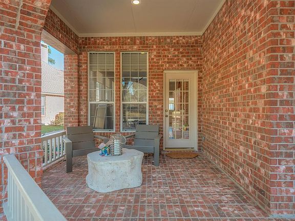 wrap around covered brick front porch with private entrance into sun room.