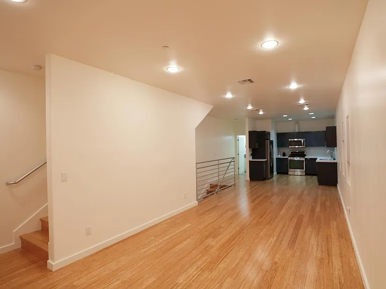 Living & Dining Rooms Adjoining Kitchen Area; Staircase Leading to Upstair Bedrooms