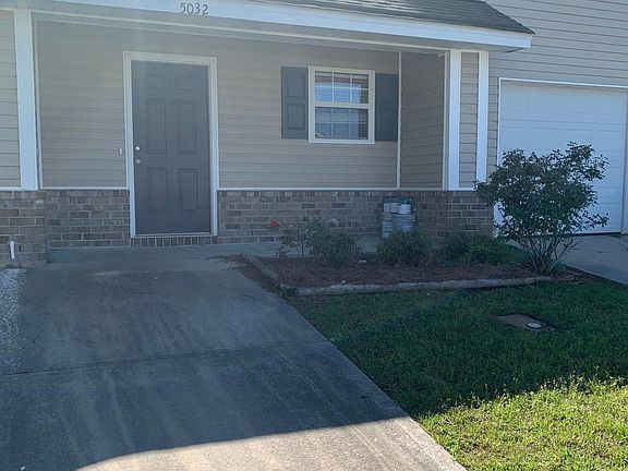 Front of townhome and driveway parking