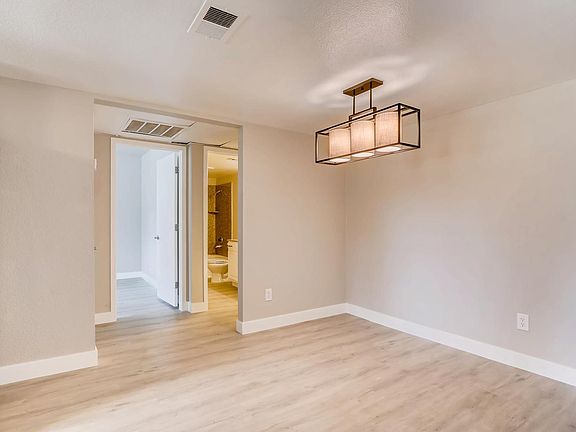 Separate dining area with designer chandelier.