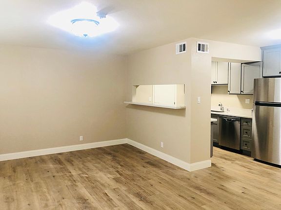 Living room with ceiling lights and large bright windows.