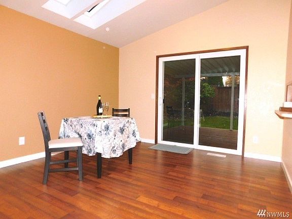 Large dining area with sliding glass door to covered deck.
