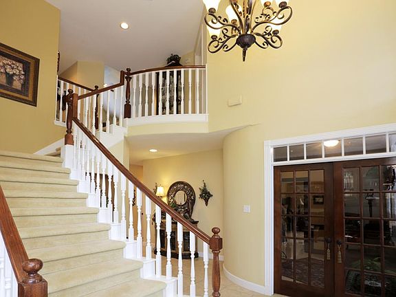 Study is located off the foyer with French doors and transom window for privacy. Updated light fixtu