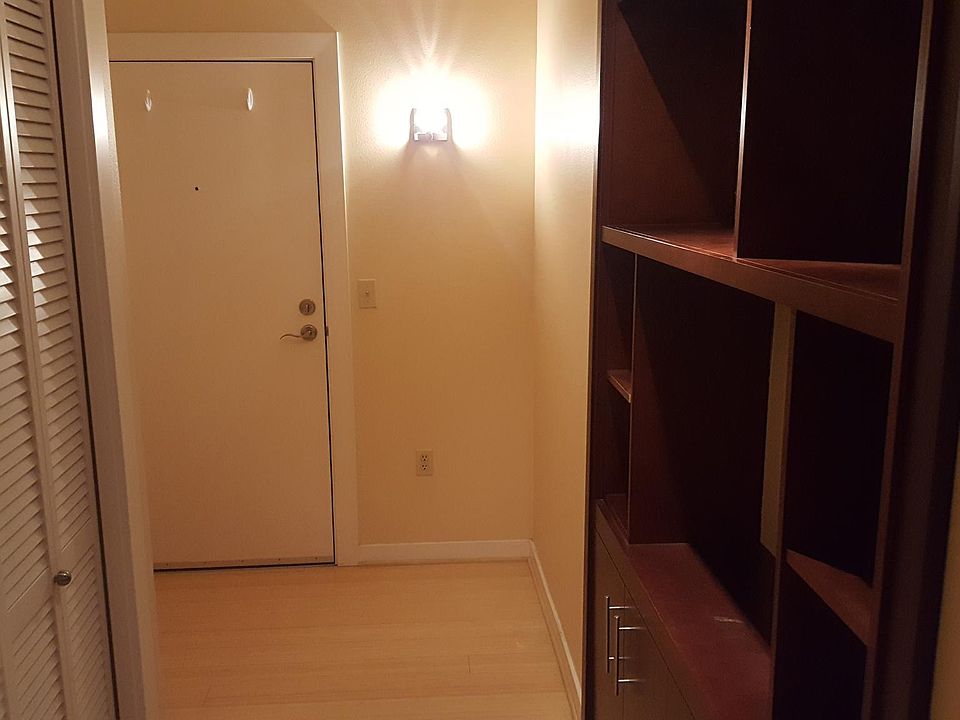Entryway with built in display shelves and coat closet