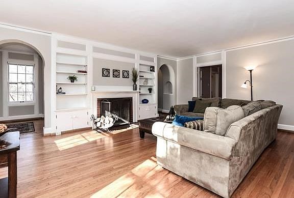 A view from the doors to the porch. Notice built in book shelves and custom millwork.