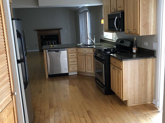 View of kitchen to family room with fireplace