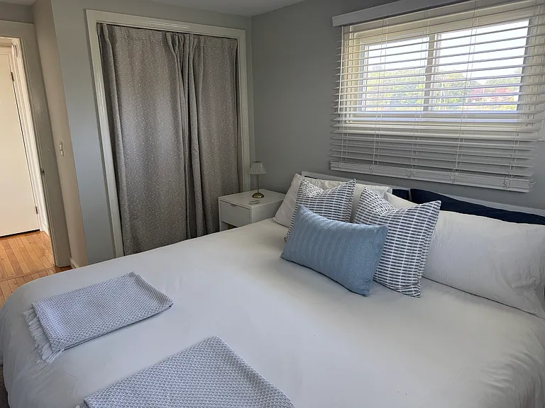 King size bed, large bureau, 2 night stands, chair in corner and tv on opposite wall.