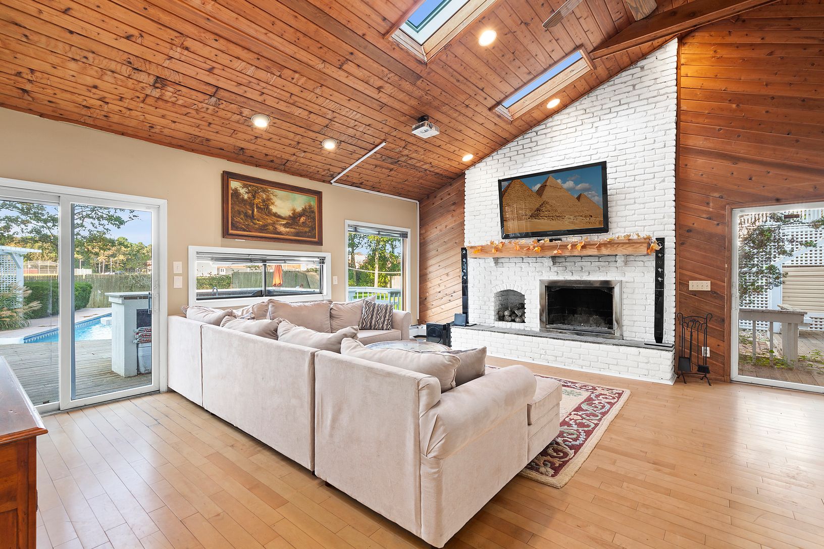  Media room with vaulted ceiling and fireplace