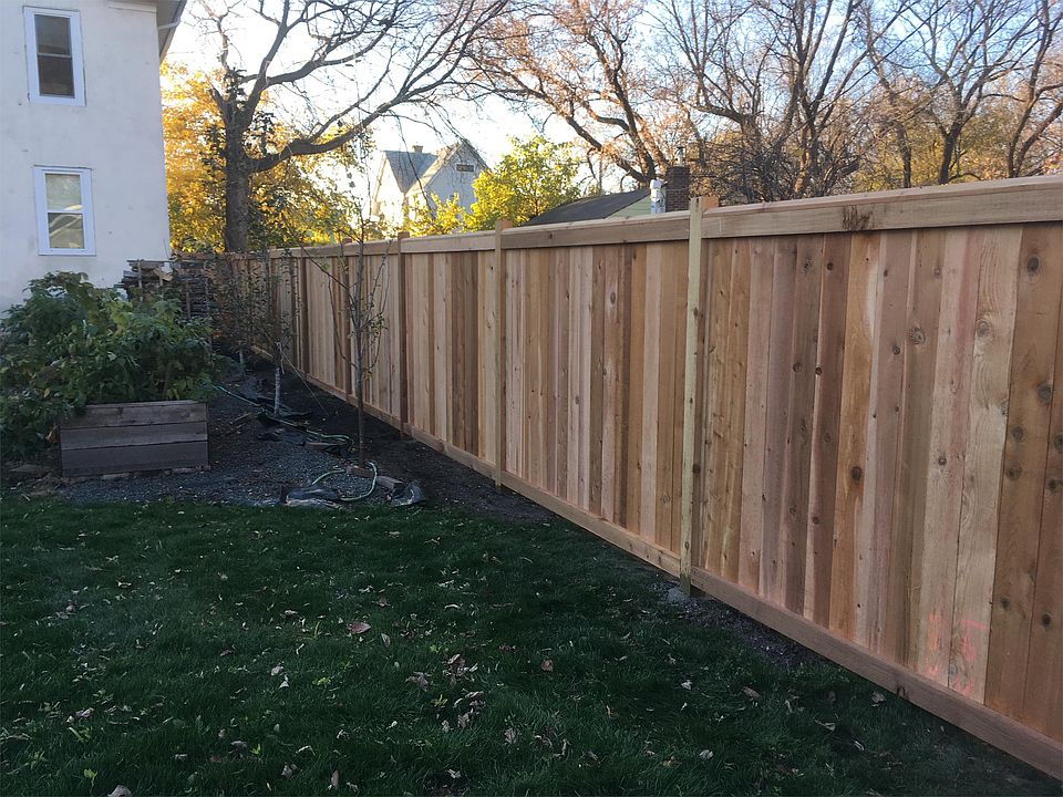 Newly seeded grass and installed cedar wood privacy fence.