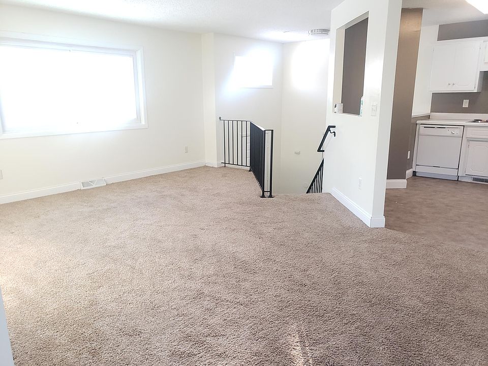 Living room with staircase going down.
