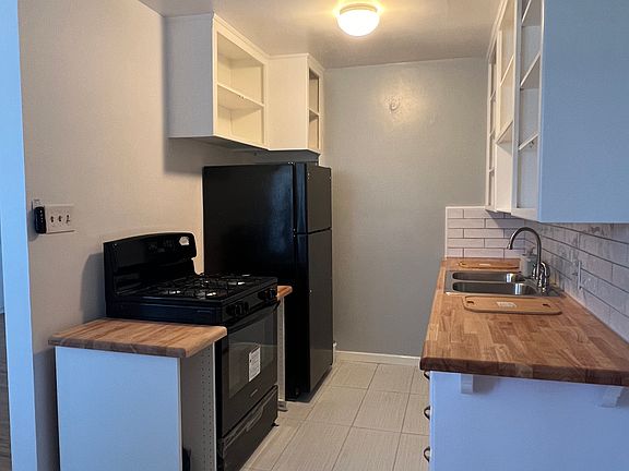 Newly renovated kitchen. Doors will be attached this week. New counters, floor and Backsplash.