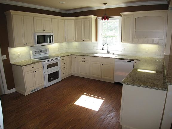 Remodeled kitchen features granite countertops, new cabinets and newer appliances.
