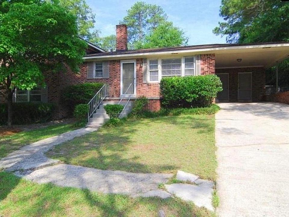 Spacious front yard with trees for shade. Carport closets for laundry and storage.