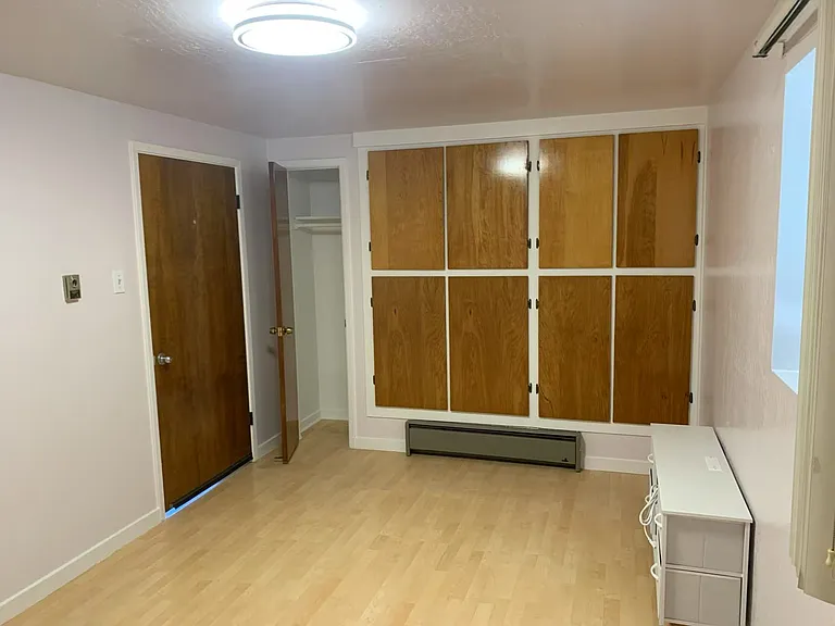 Different view of the bedroom with storage and closet space