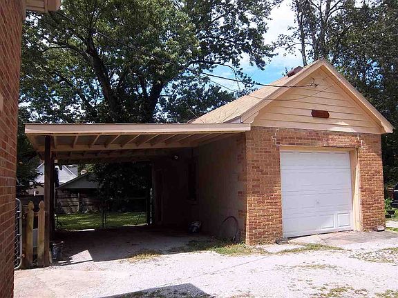 Small detached garage with carport.  Along with workshop building 18x22