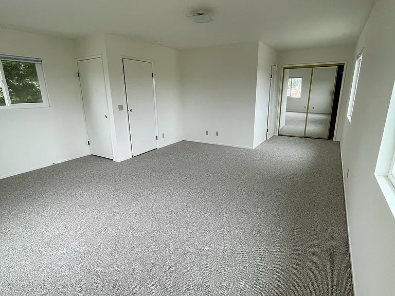 XL, Sunny Upstairs Room looking toward mirrored closet doors and bathroom