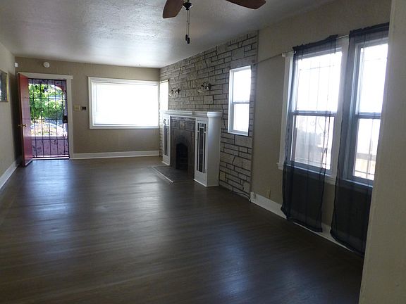 Living room and dining room combination with refinished hardwood floors.
