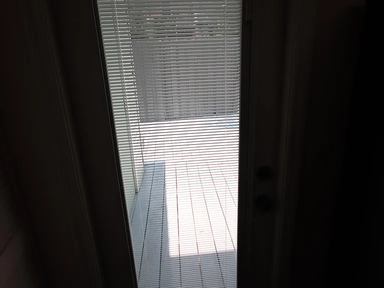 Rear door off Kitchen to patio has built-in blinds.