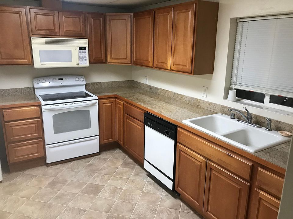 Kitchen with upgraded stove/oven, granite tile countertops and a dishwasher