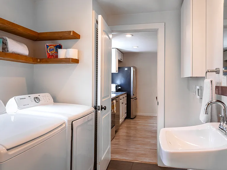 Washer/Dryer in bathroom, looking into kitchen