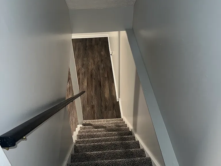 Stairs to partially finished basement.