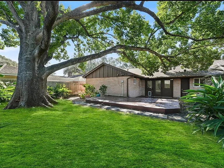 Welcoming backyard with mature landscape and lots of shade.