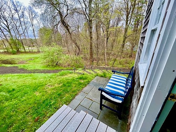 The apartment has it's own private entrance with a small patio and seating area overlooking an acre of shared land and gardens