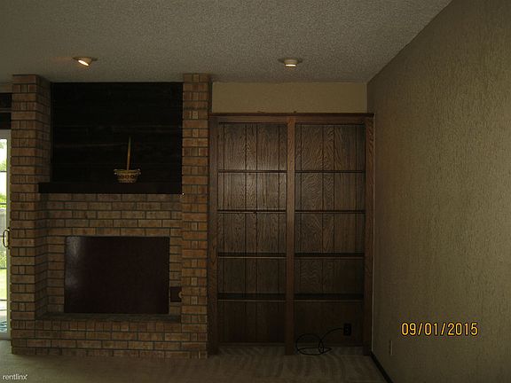 Built-in book shelve in living room next to Fire Place