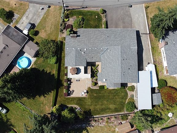 Aerial shot, manicured yard parking for LOTS of vehicles! Covered 40ft RV area.