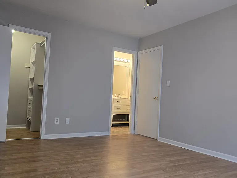 Master bedroom with custom walk-in closet and ensuite bath