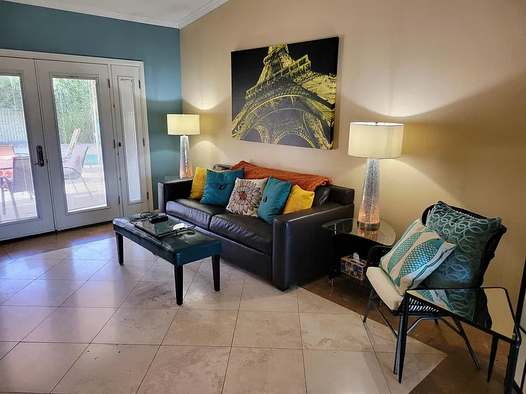 Leather sleeper sofa, vaulted ceilings and pool view living room