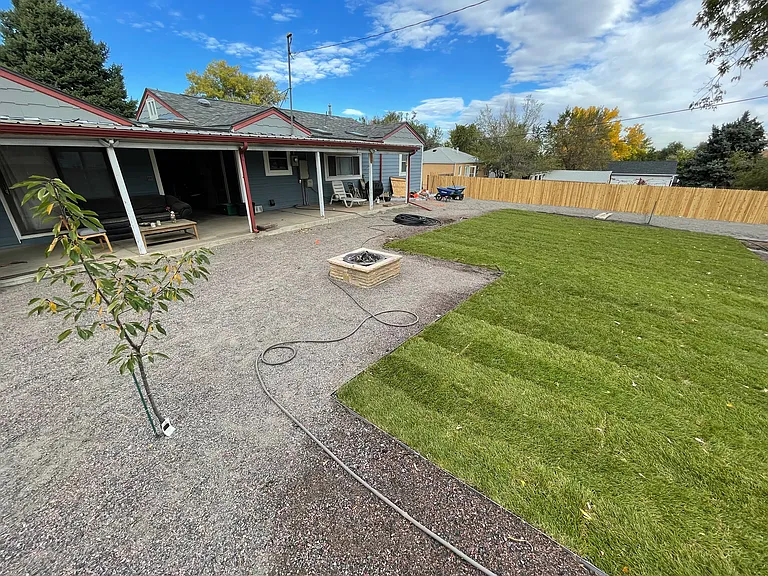 Large back yard, fire pit, and covered back patio area