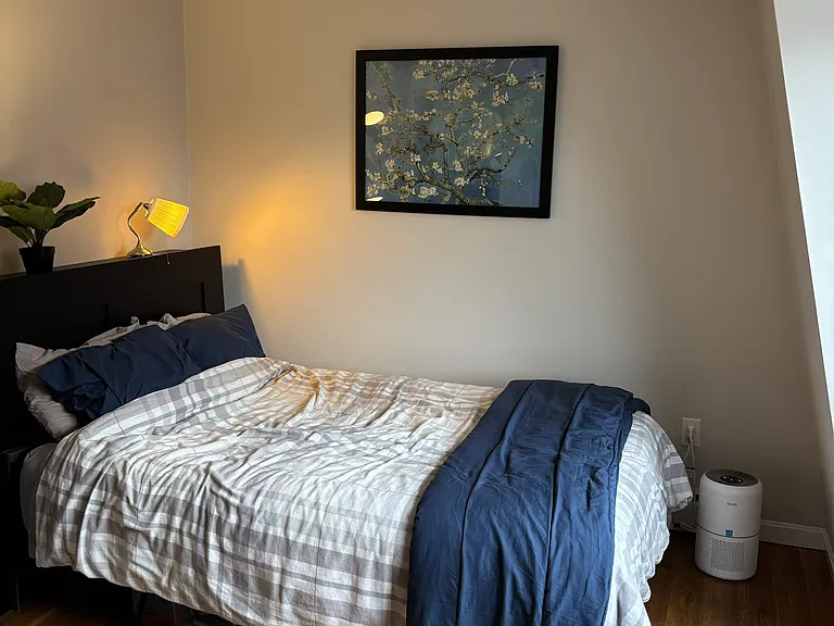Large bedroom with dresser, in-wall air-conditioner, closet, and large windows that get the morning sunlight.