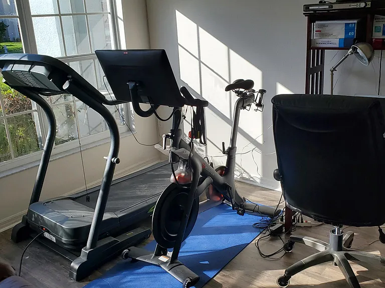 spin bike office and treadmill along with office chair and desk