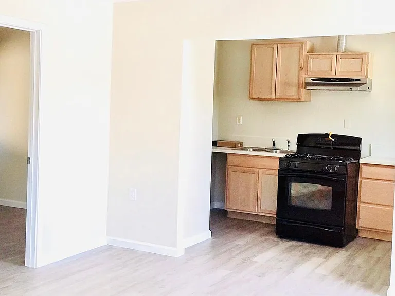 Living room with entry into rooms / kitchen