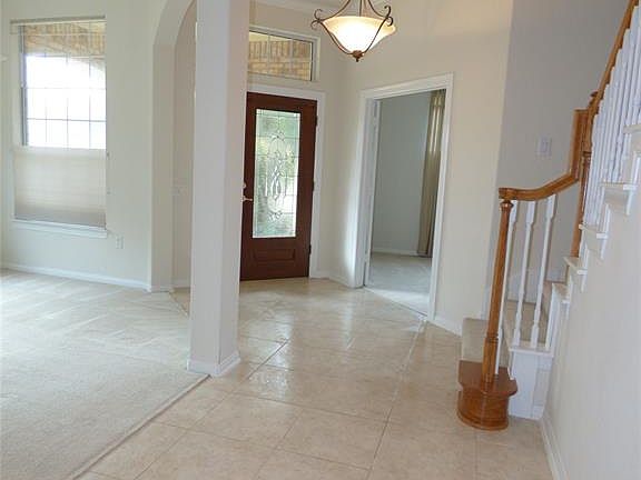 Tile floors welcome you into this home and usher you past the study and formal dining room towards the open family room and kitchen area.