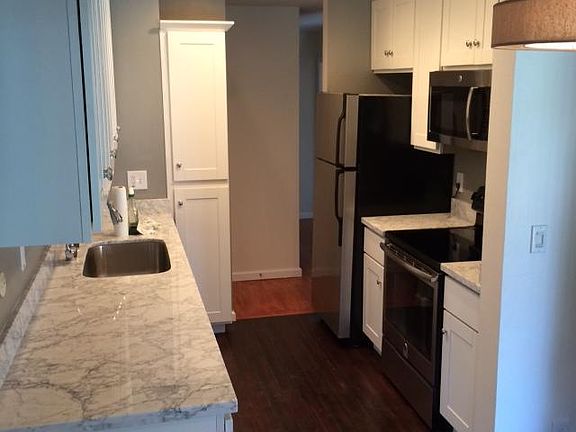 Kitchen with dishwasher & microwave.