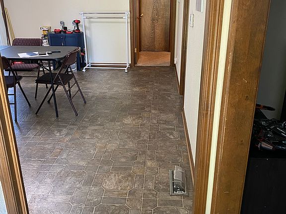 View from front door. Living room immediately right. Bedrooms beyond the dining area, then to the right.