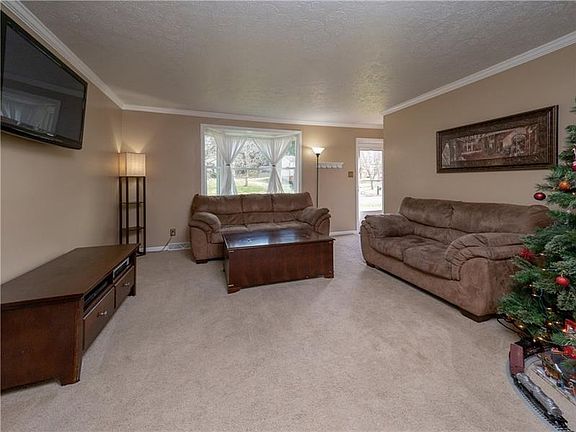 Another view of the family room from the kitchen eating area.  Spacious and bright just waiting for your styling.