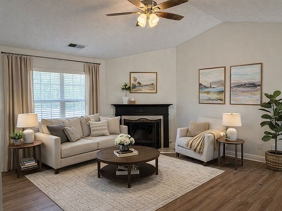 Spatial living room with fireplace for cozy evenings.