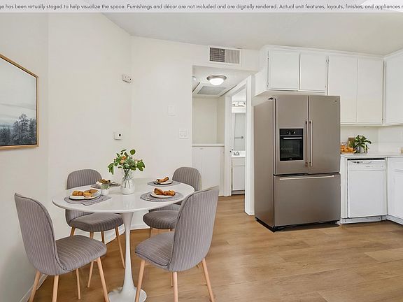 Open kitchen and dining area featuring ample cabinet space and a functional layout.