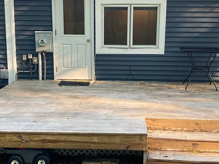 Private entrance, large deck outside, gravel walkway