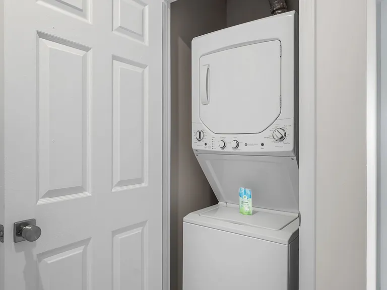 Upstairs hallway has a closet. Closet space holds the unit washer and dryer